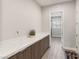 Bright laundry room with modern cabinets and quartz countertops at 5860 Noah Springs Ct, Las Vegas, NV 89149