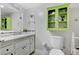 Bright bathroom featuring updated vanity, fixtures and a green cabinet at 5880 W Oquendo Rd, Las Vegas, NV 89118