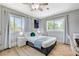 Well-lit bedroom with a queen bed and hardwood floors at 5880 W Oquendo Rd, Las Vegas, NV 89118