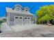 Two-car garage with gray exterior and dormer windows at 5880 W Oquendo Rd, Las Vegas, NV 89118