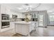 Bright kitchen with white cabinets, large island, and stainless steel appliances at 5880 W Oquendo Rd, Las Vegas, NV 89118