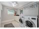 Bright laundry room with washer, dryer, and storage cabinets at 5880 W Oquendo Rd, Las Vegas, NV 89118