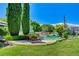 Relaxing pool area with lounge chairs and brick fireplace at 5880 W Oquendo Rd, Las Vegas, NV 89118