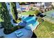 Aerial view of luxurious pool and spa, surrounded by lush landscaping and recreational amenities at 5880 W Oquendo Rd, Las Vegas, NV 89118