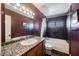 Clean bathroom with granite countertop, dark tile, and a bathtub at 6232 Lanning Ln, Las Vegas, NV 89108