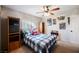 Bright bedroom featuring a bed with plaid bedding and wood shelving at 6232 Lanning Ln, Las Vegas, NV 89108