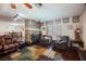 Living room with dark leather seating and a stone fireplace at 6232 Lanning Ln, Las Vegas, NV 89108