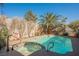 Relaxing pool and spa area with palm trees and colorful accents at 6232 Lanning Ln, Las Vegas, NV 89108