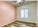 Bedroom with pink accent wall and wood-look flooring at 6232 Novak St, Las Vegas, NV 89115