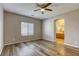 Bright bedroom featuring wood-look floors and access to bathroom at 6232 Novak St, Las Vegas, NV 89115