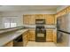 Well-equipped kitchen, showcasing modern appliances and wood cabinets at 6232 Novak St, Las Vegas, NV 89115