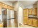 Kitchen boasts stainless steel refrigerator and ample wood cabinetry at 6232 Novak St, Las Vegas, NV 89115