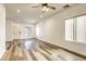 Bright living room with wood-look floors and ceiling fan at 6232 Novak St, Las Vegas, NV 89115