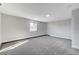 Bright bedroom with grey carpeting and a window offering natural light at 6252 Fairwood Ave, Las Vegas, NV 89107