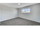 Bright bedroom with grey carpet and a window view at 6252 Fairwood Ave, Las Vegas, NV 89107