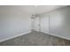 Bedroom with grey carpet, mirrored closet doors and access to bathroom at 6252 Fairwood Ave, Las Vegas, NV 89107