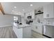 Modern kitchen with white cabinets, large island, and stainless steel appliances at 6252 Fairwood Ave, Las Vegas, NV 89107