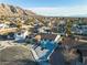 Aerial view of a home with a well-kept front yard, in a neighborhood with mountain views at 6255 Adenmoor Ct, Las Vegas, NV 89156