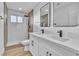 Modern bathroom with double sink vanity, walk-in shower with rainfall showerhead, and neutral color palette at 6255 Adenmoor Ct, Las Vegas, NV 89156