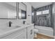 Stylish bathroom showcasing a double sink vanity, modern fixtures, and tiled shower with a tub at 6255 Adenmoor Ct, Las Vegas, NV 89156