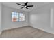 Bright bedroom with a large window and modern ceiling fan at 6255 Adenmoor Ct, Las Vegas, NV 89156