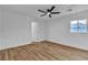 Bright bedroom with ceiling fan, light-colored wood flooring, and a window at 6255 Adenmoor Ct, Las Vegas, NV 89156