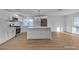 Modern kitchen featuring stainless steel appliances, white cabinetry, and a central island, enhancing functionality and style at 6255 Adenmoor Ct, Las Vegas, NV 89156