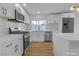 Well-lit kitchen with stainless steel appliances, custom cabinets, and a center island at 6255 Adenmoor Ct, Las Vegas, NV 89156