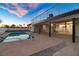 Backyard pool featuring clear water and a patio under a balcony at 6255 Adenmoor Ct, Las Vegas, NV 89156