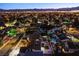 Night-time aerial view of a residential neighborhood with houses and a pool at 6584 Banbridge Dr, Las Vegas, NV 89103