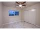 Bedroom with white sliding doors and tile flooring at 6584 Banbridge Dr, Las Vegas, NV 89103