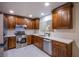 Modern kitchen with wood cabinets, stainless steel appliances, and quartz countertops at 6584 Banbridge Dr, Las Vegas, NV 89103