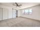 Primary bedroom with carpet flooring and barn door to en-suite bathroom at 7205 Carrondale Way, Las Vegas, NV 89128