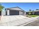 Modern house exterior with artificial turf and dark gray garage door at 7205 Carrondale Way, Las Vegas, NV 89128