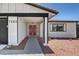 Modern house exterior with dark gray garage door and red front door at 7205 Carrondale Way, Las Vegas, NV 89128