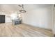 Light and airy living room featuring hardwood floors and open kitchen view at 7205 Carrondale Way, Las Vegas, NV 89128