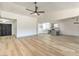 Open concept living room with kitchen and light hardwood floors at 7205 Carrondale Way, Las Vegas, NV 89128