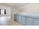 Upper floor hallway with gray cabinets and hardwood floors at 7445 Shangri La Ave, Las Vegas, NV 89147