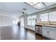 Open concept kitchen and living area with dark tile floors at 7445 Shangri La Ave, Las Vegas, NV 89147