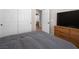 Bedroom with grey bedding, dresser, and a view of the bathroom at 8474 Orange Cliff Ct, Las Vegas, NV 89123