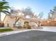 Exterior view of home with desert landscaping, front yard, and a driveway at 8474 Orange Cliff Ct, Las Vegas, NV 89123