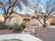 Charming front exterior with desert landscaping, stone accents, and an attached garage at 8474 Orange Cliff Ct, Las Vegas, NV 89123