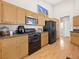 Well-equipped kitchen with wood cabinets and black appliances at 8474 Orange Cliff Ct, Las Vegas, NV 89123