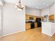 Eat-in kitchen with chandelier, wood cabinets, and black appliances at 8474 Orange Cliff Ct, Las Vegas, NV 89123