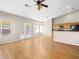 Bright, open-concept living room with hardwood floors, ceiling fan, and access to the kitchen at 8474 Orange Cliff Ct, Las Vegas, NV 89123