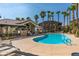 Community swimming pool with lounge chairs and palm trees at 8805 Jeffreys St # 1019, Las Vegas, NV 89123