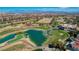 Expansive aerial of a golf course community, featuring lush greenery, scenic water features, and mountain views at 8941 Diamond Falls Dr, Las Vegas, NV 89117