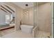 Spa-like bathroom featuring a freestanding tub and a walk-in shower at 8941 Diamond Falls Dr, Las Vegas, NV 89117