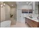 This contemporary bathroom features a soaking tub, glass shower, and modern vanity with dual sinks at 8941 Diamond Falls Dr, Las Vegas, NV 89117