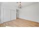 Bright bedroom with light wood floors features a modern light fixture and closet at 8941 Diamond Falls Dr, Las Vegas, NV 89117